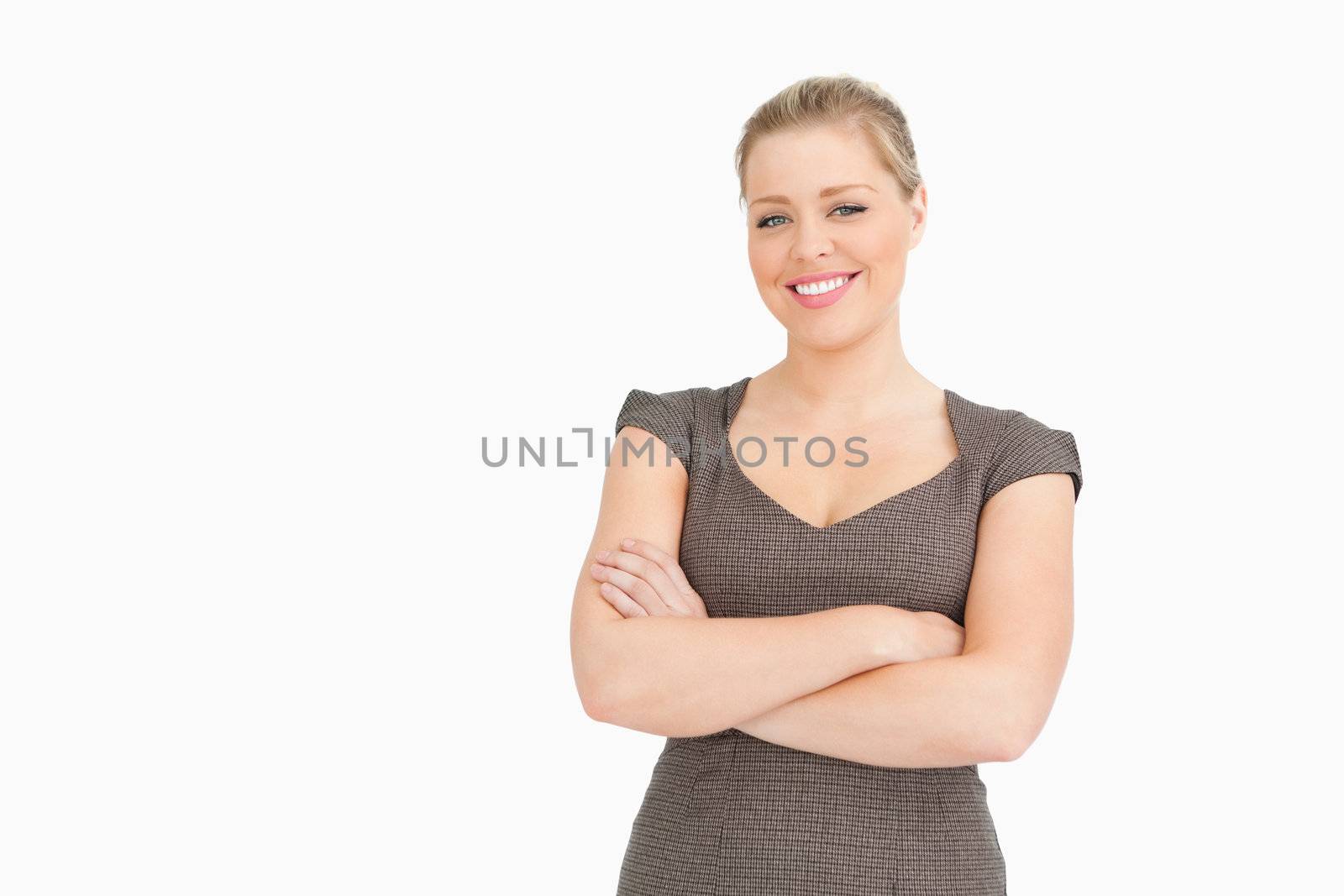 Woman standing with her arms crossed against white background