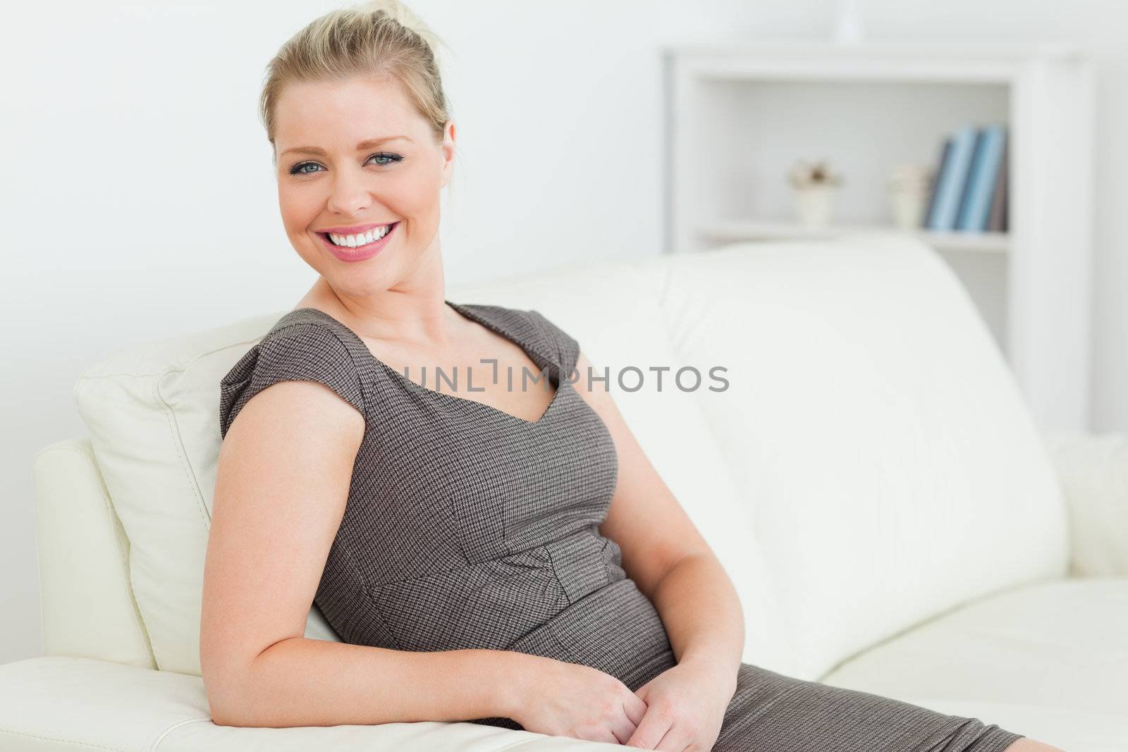 Smiling woman sitting on a sofa in a living room