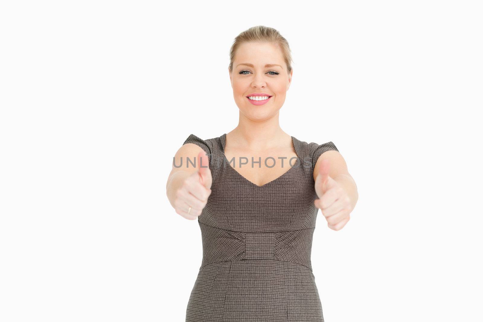 Woman showing thumbs up against white background