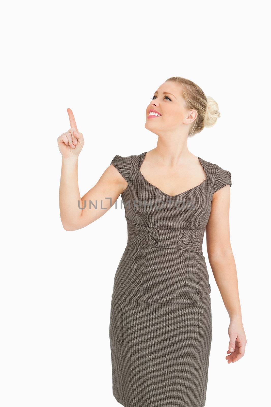 Woman pointing something up against white background