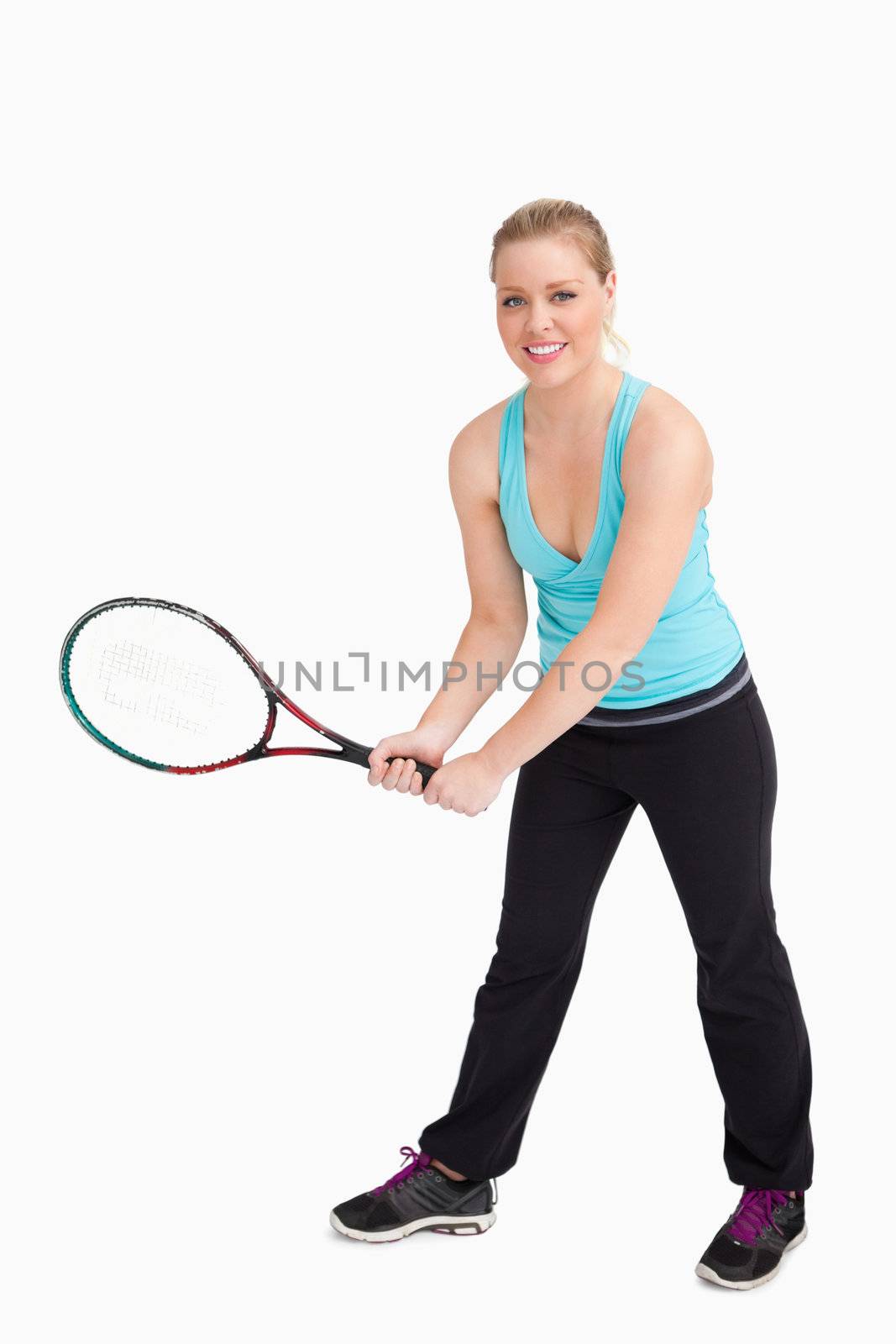 Woman holding a racquet with her two hands against white background