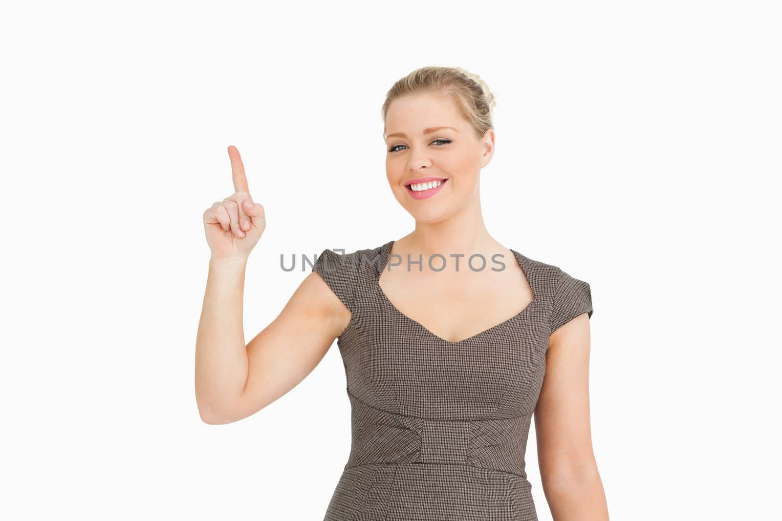 Pretty woman pointing something up against white background