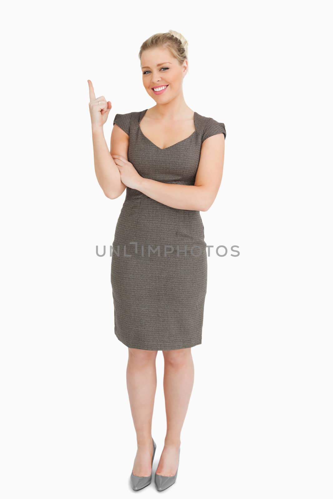 Woman smiling showing something with her finger against white background