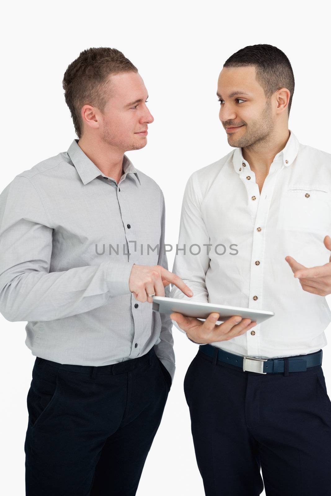 Two men together while holding a tablet computer by Wavebreakmedia