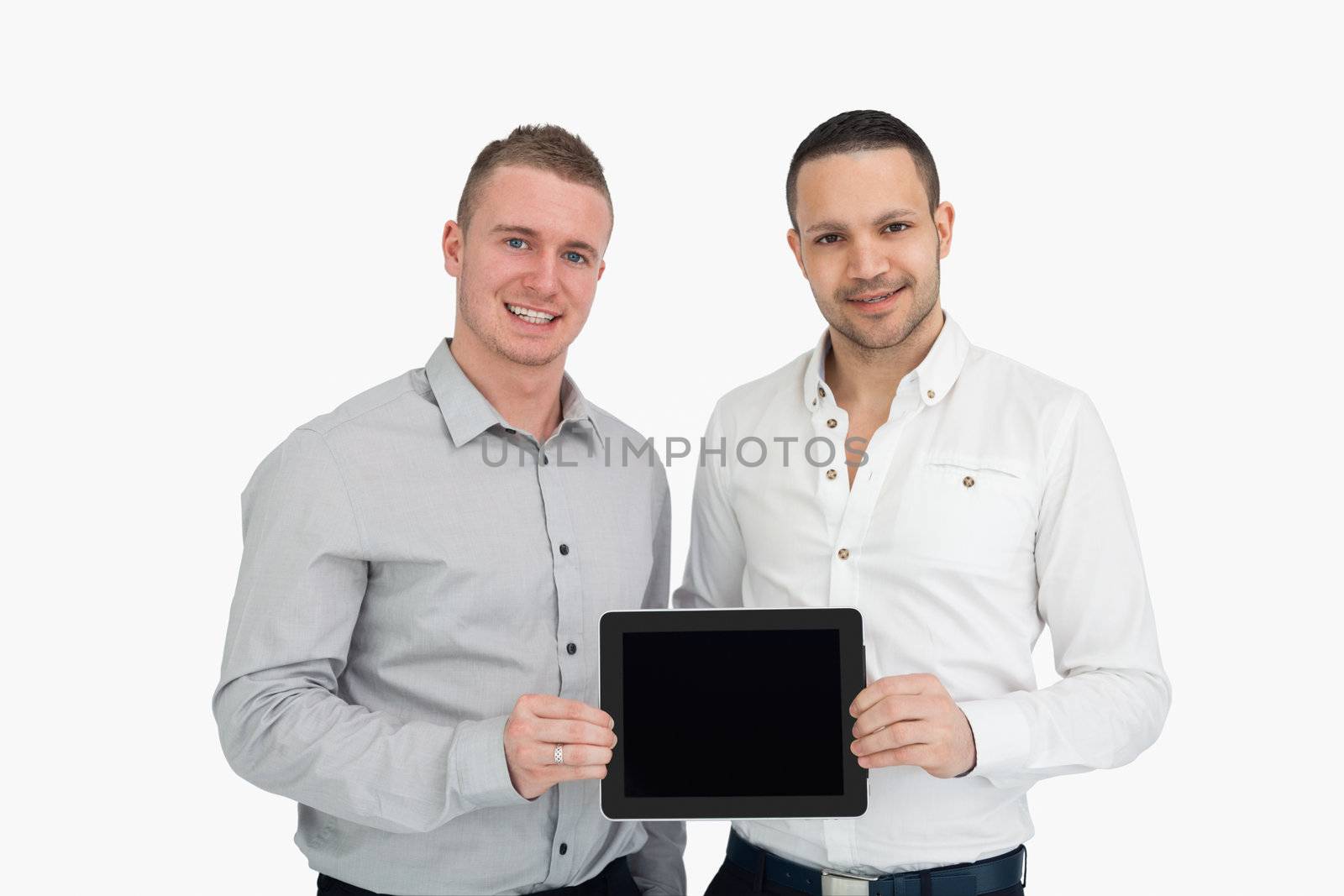 Two smiling men holding a tablet computer against a white background