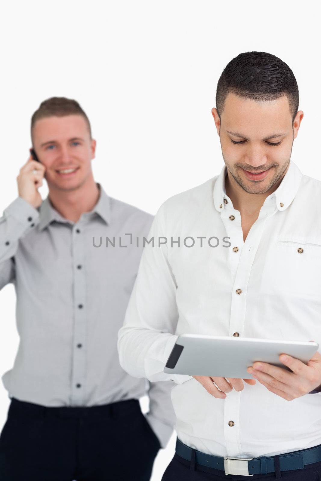 Men using phone and tablet computer by Wavebreakmedia