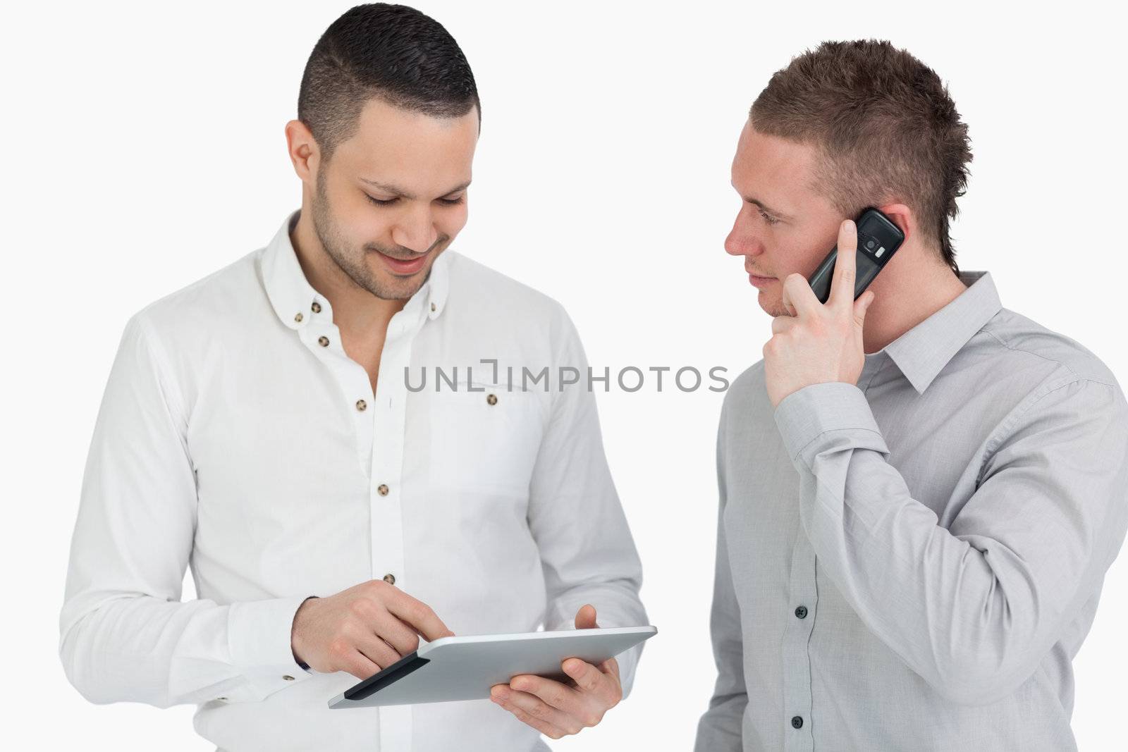 Two men calling and using a tablet computer by Wavebreakmedia