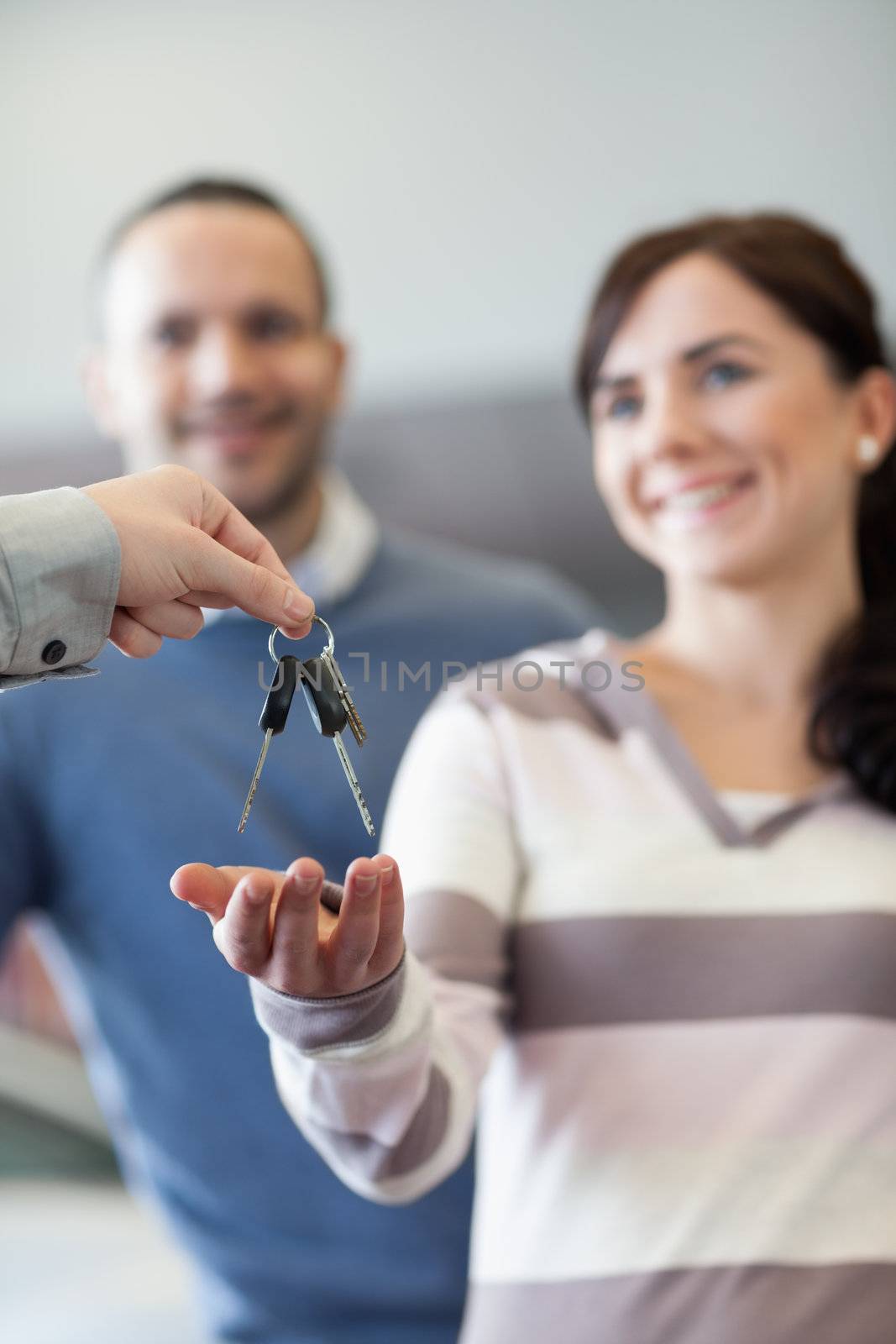 Couple receiving keys in a car shop
