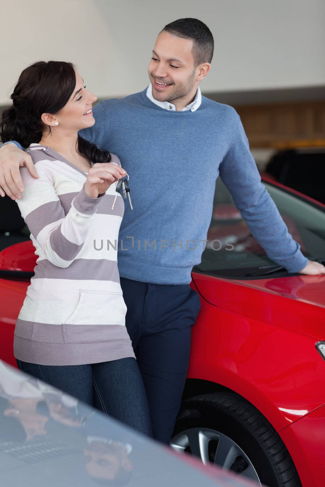 Couple standing next to a car by Wavebreakmedia