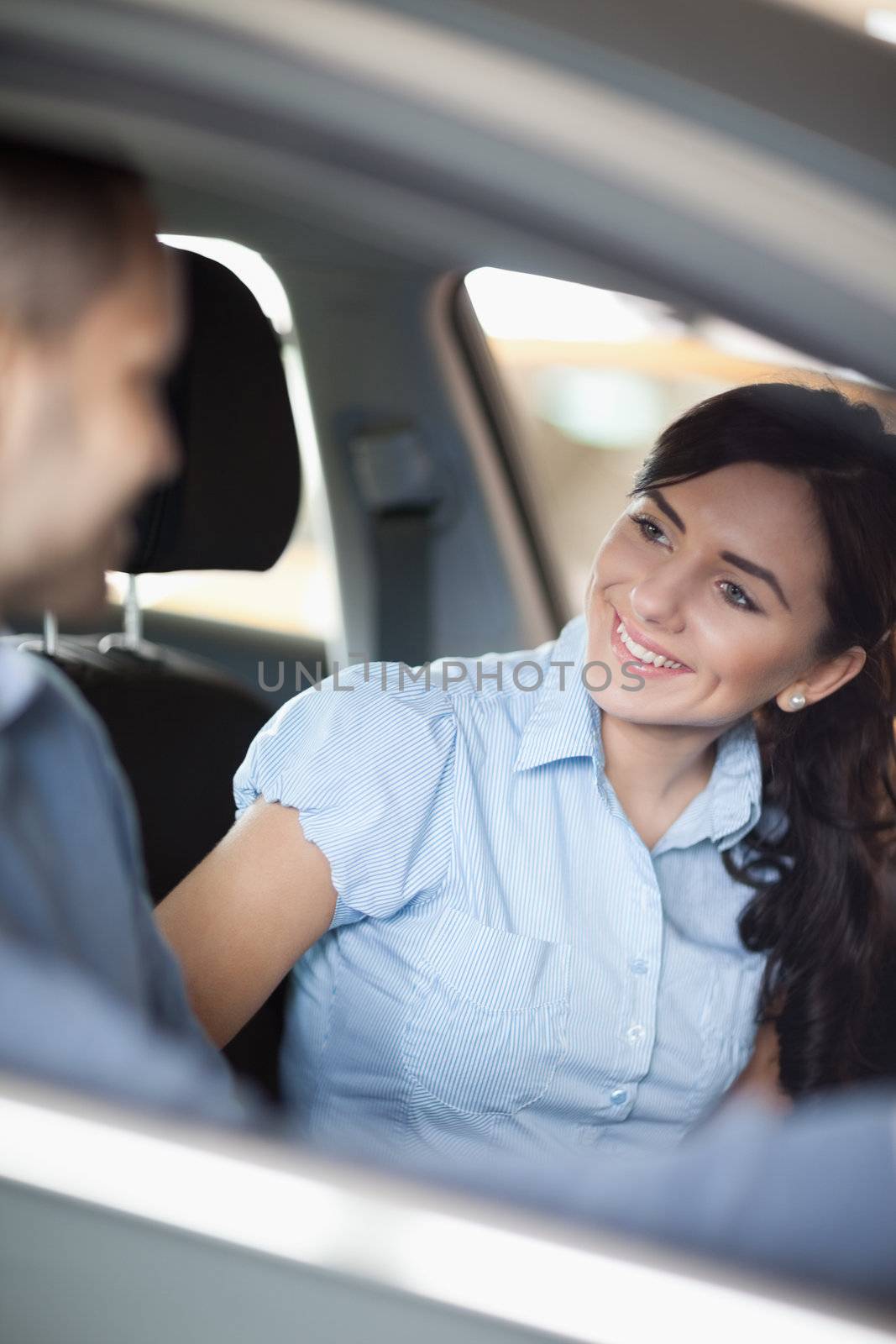 Woman smiling to a man in a car