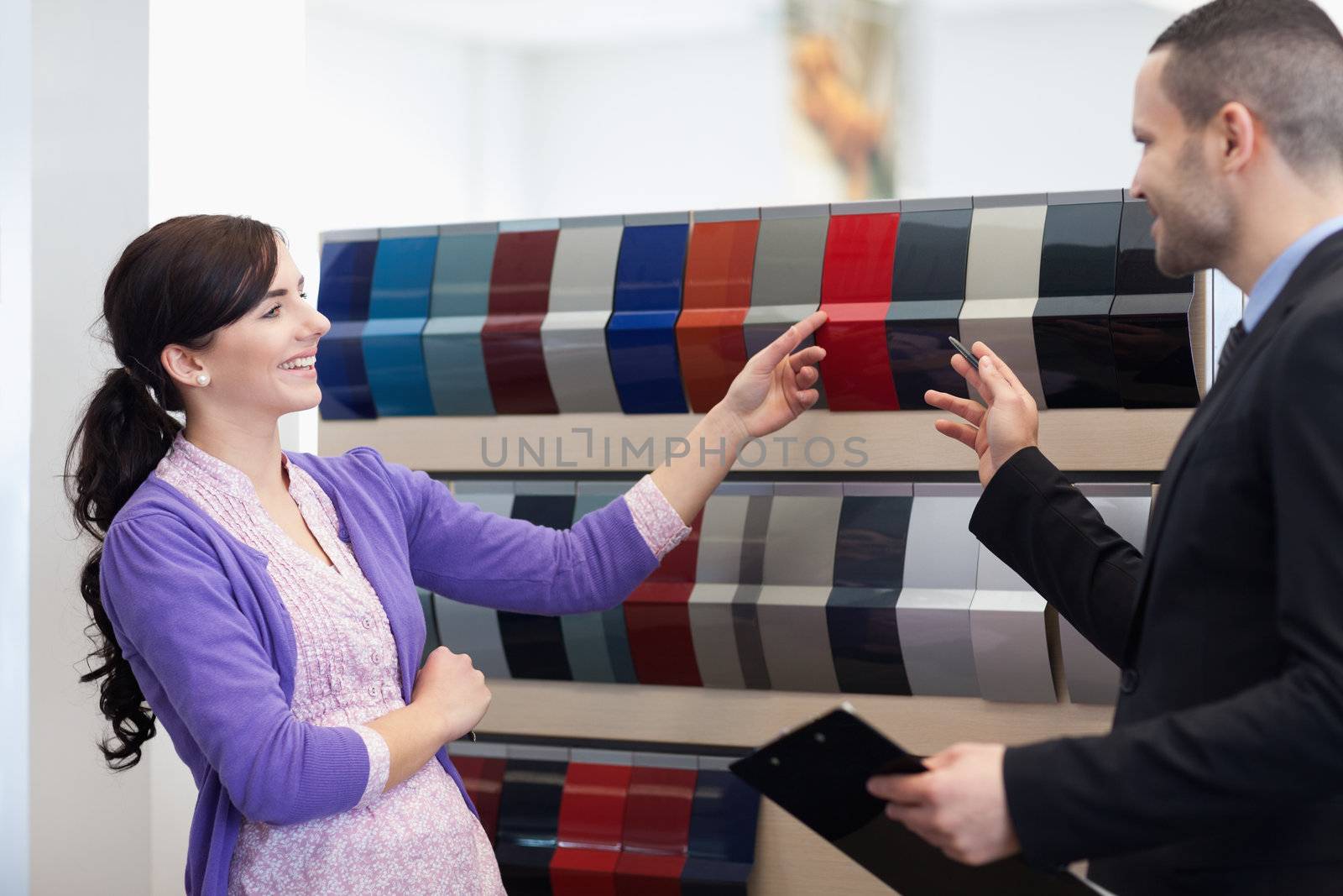 Man and woman choosing color in a color palette while smiling