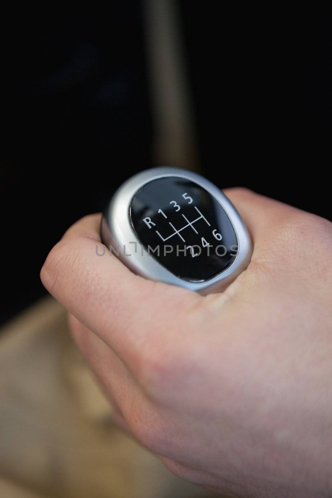 Man holding a gear stick in a car dealership