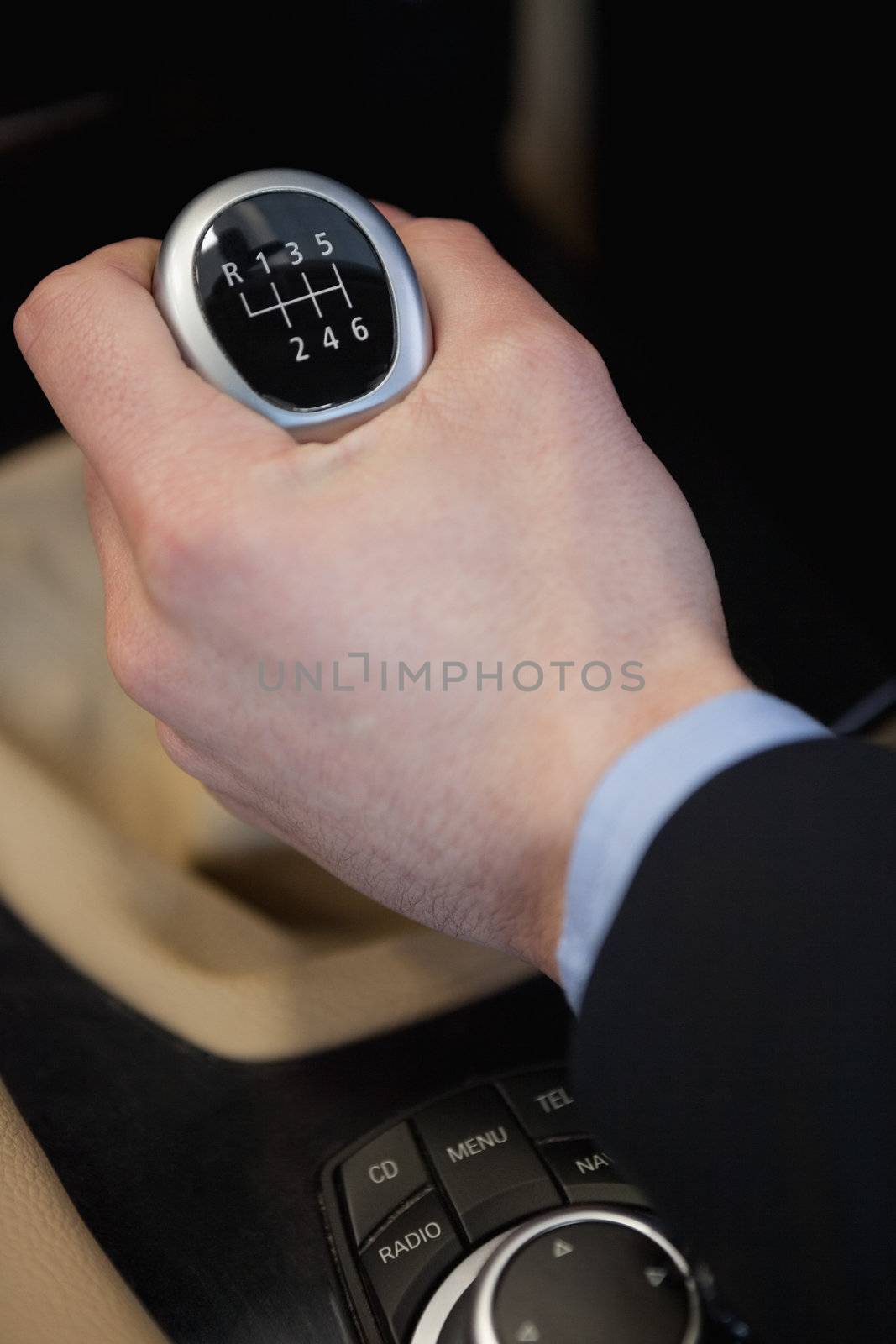 Man using a gear stick in a car dealership