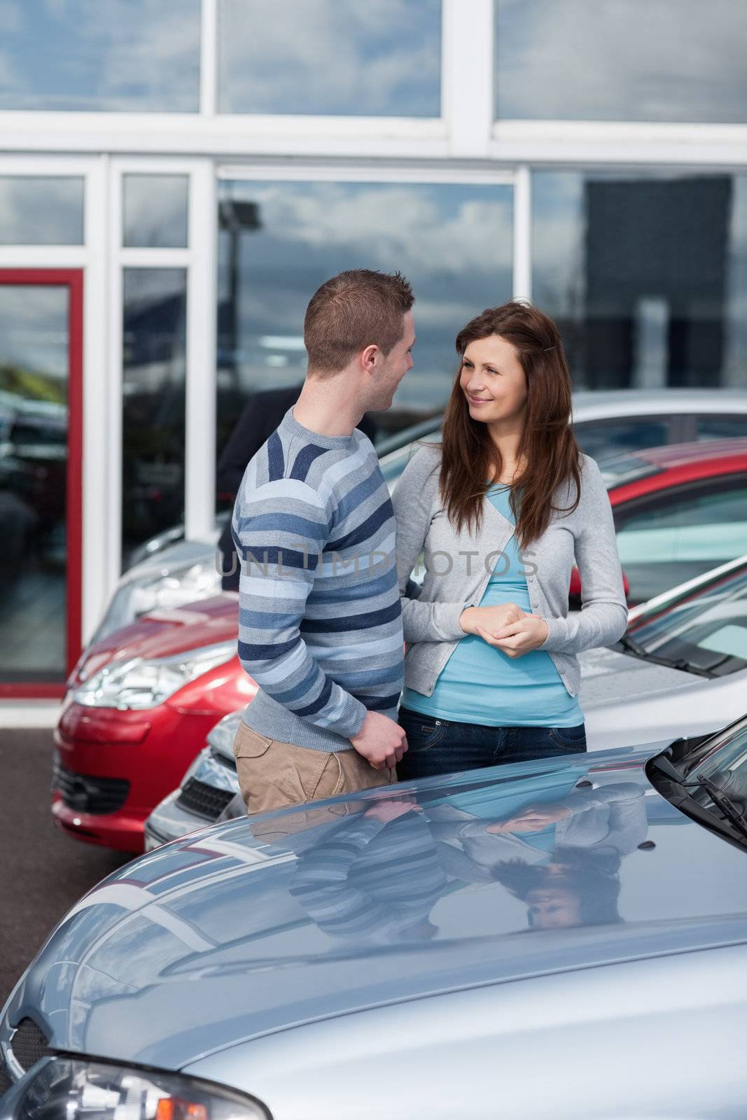 Couple buying a car in a dealership