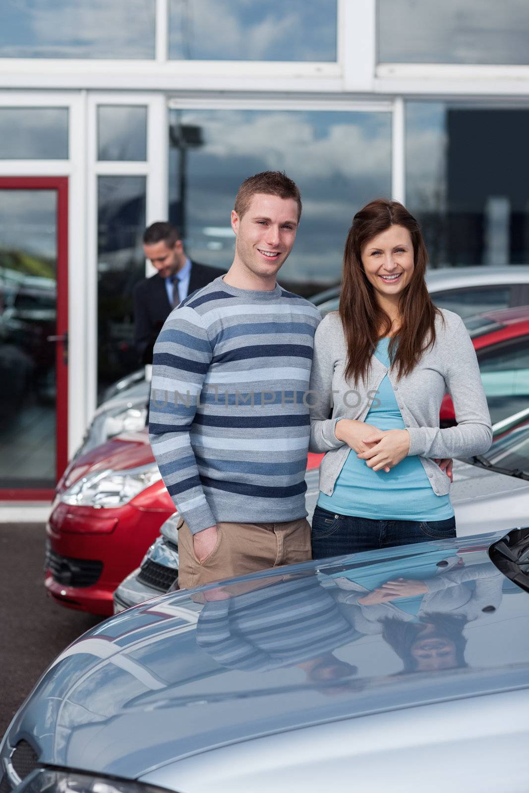 Couple choosing a car in a dealership