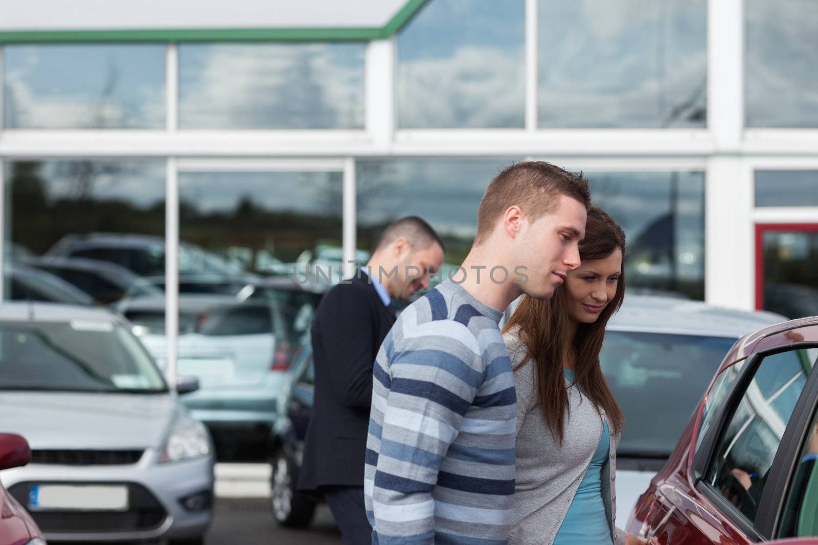 People buying a car in a dealership