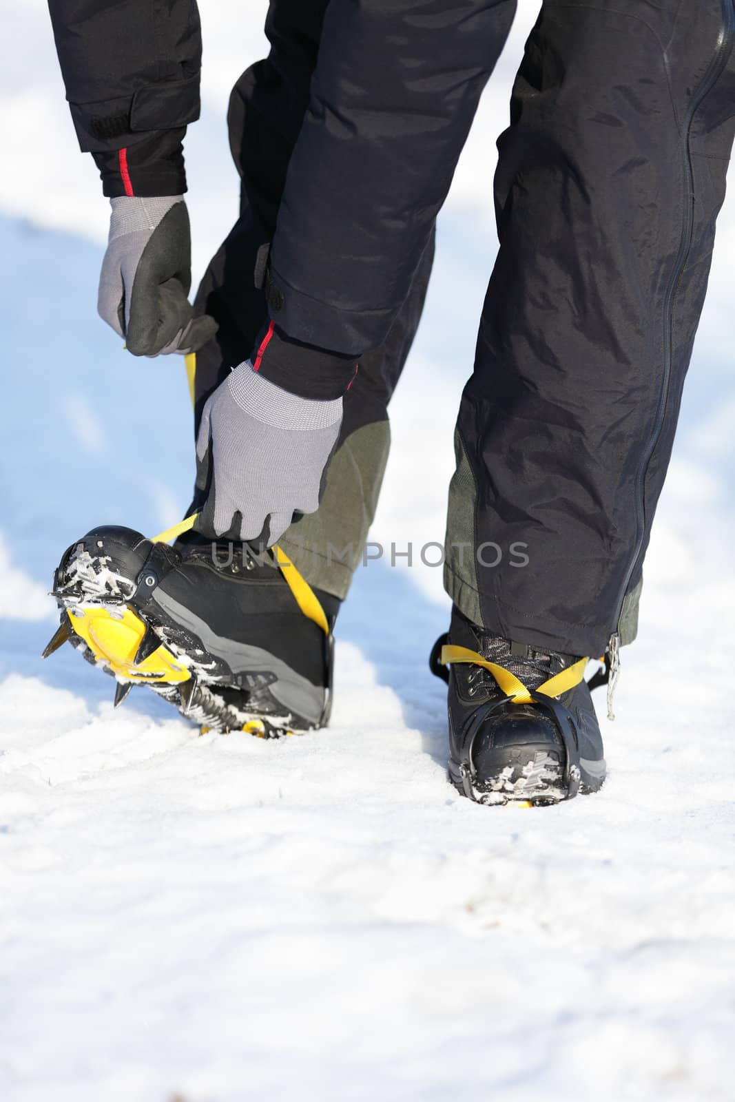 Crampons closeup. Crampons closeup. Crampon on winter boot for climbing, glacier walking or extreme hiking on ice and hard snow.