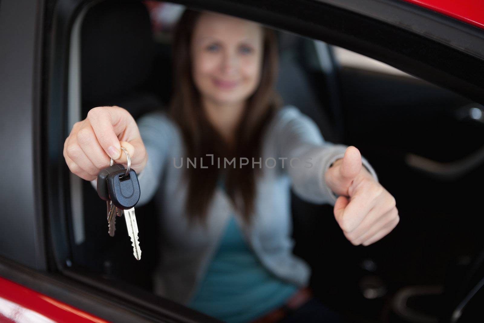 Client sitting in her car while holding car keys in her car