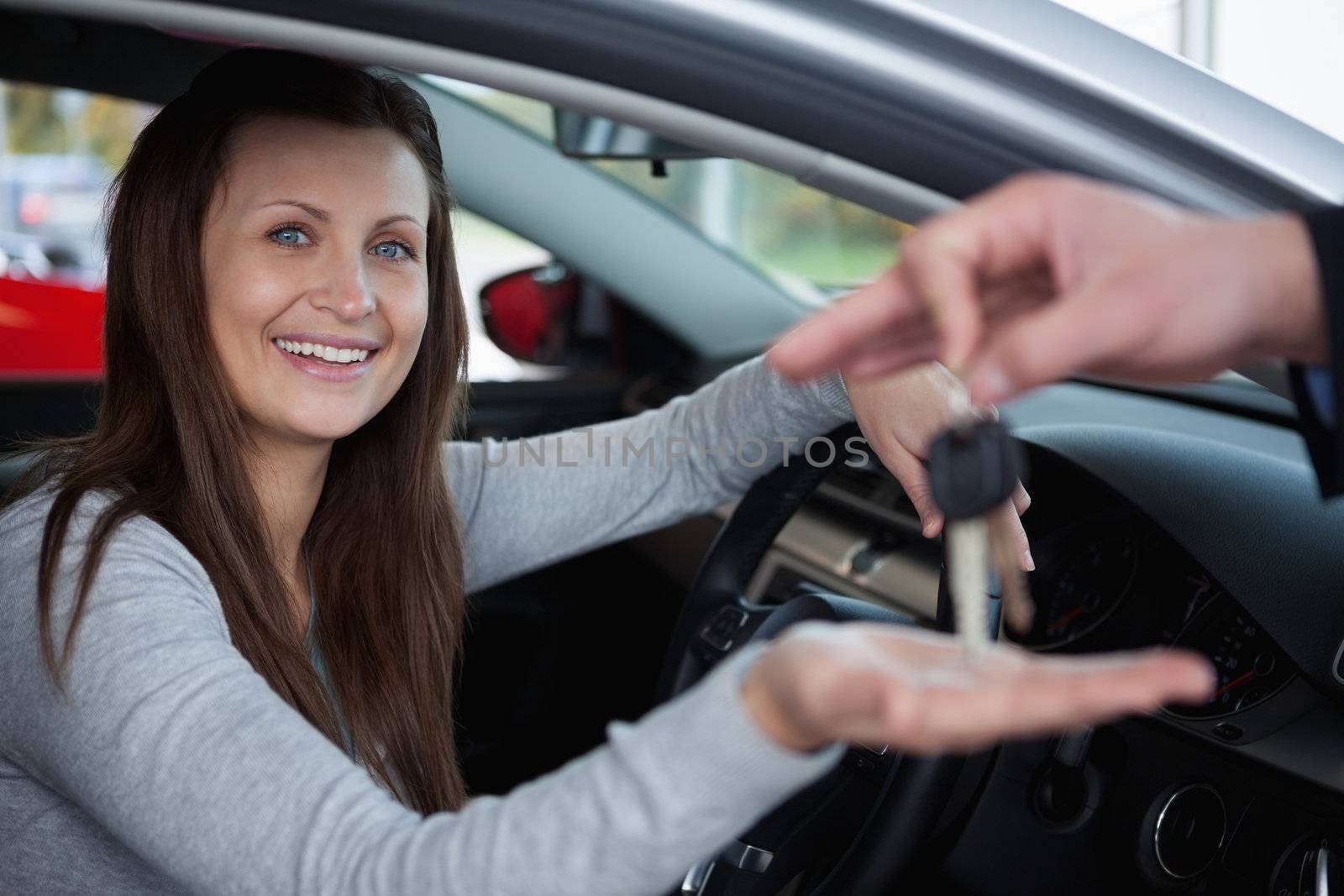 Happy client receiving car keys in a garage