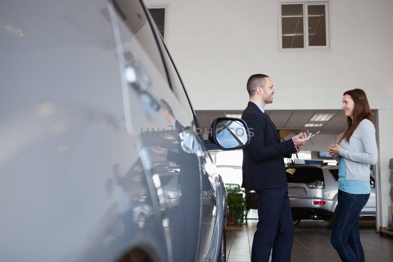 Salesman speaking with a client in a garage