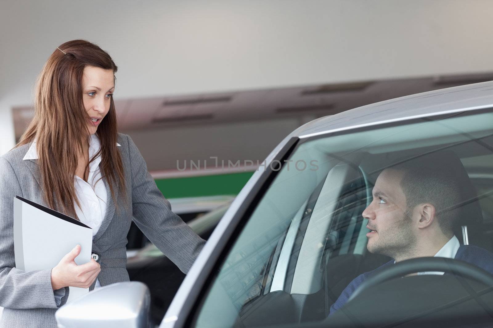 Woman speaking to a man in a garage