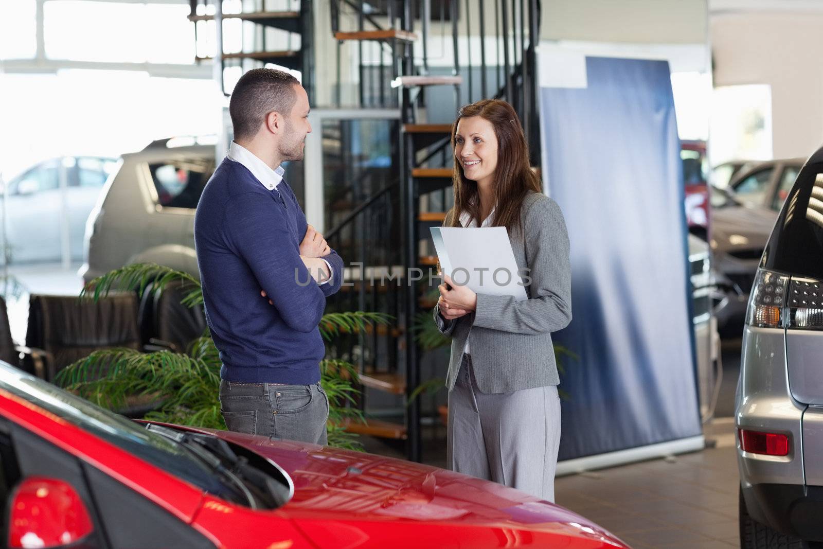 Man speaking to a woman in a dealership