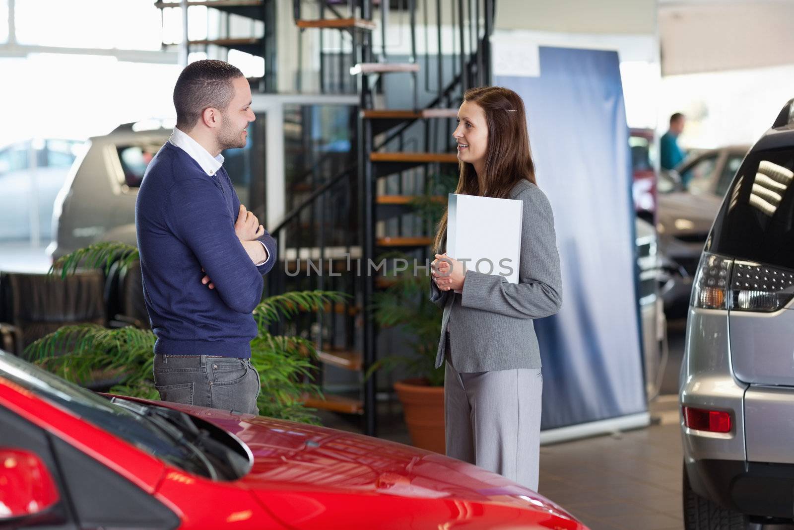 Man speaking with a businesswoman in a dealership