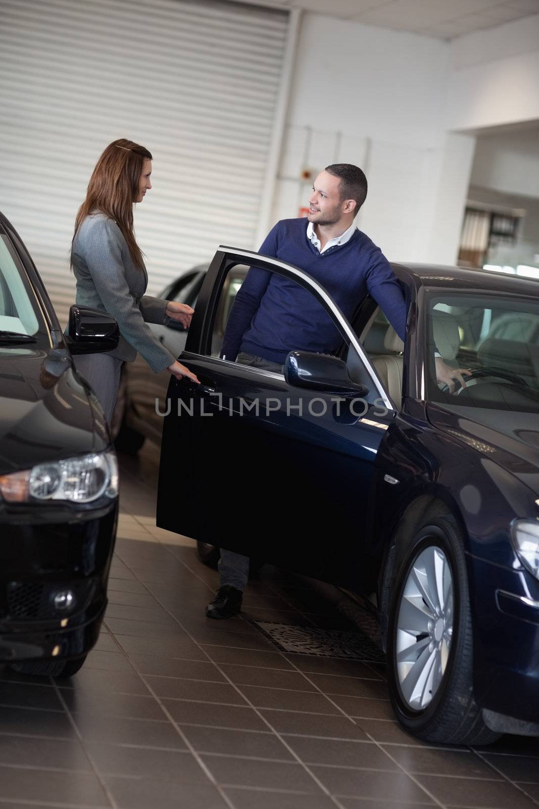 Businesswoman opening car door in a garage