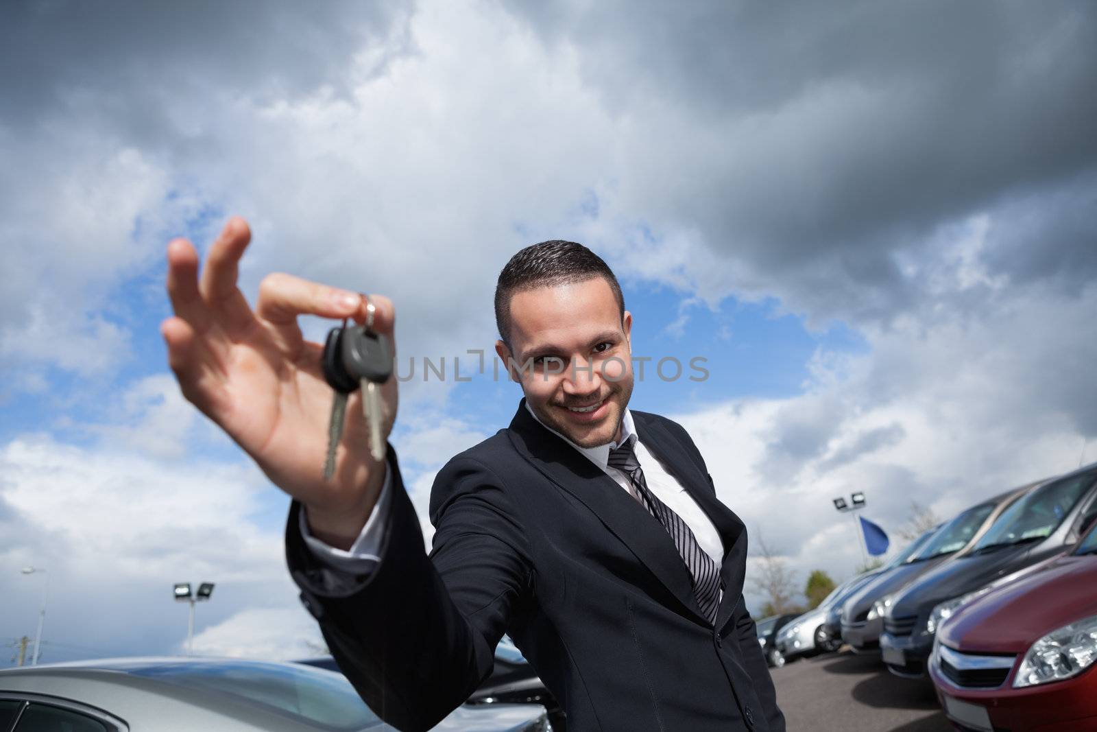 Happy seller holding car keys  by Wavebreakmedia