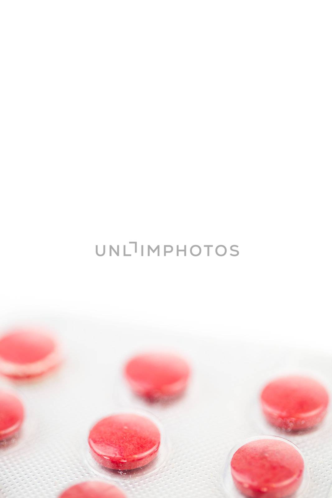 Close up of red medications against white background