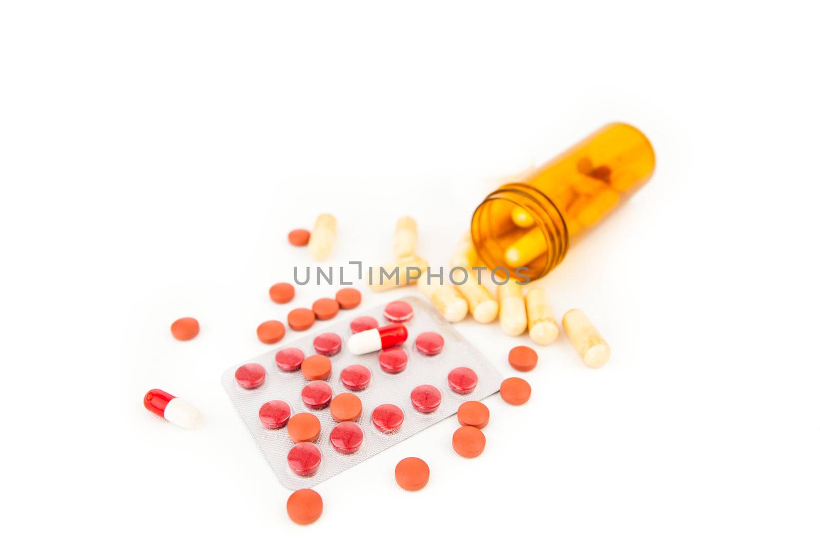 Bottle of medications knocked over against white background