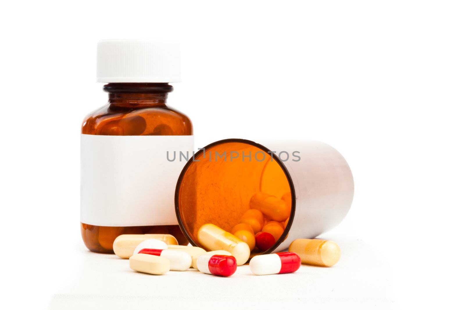 Container of medications knocked over against white background