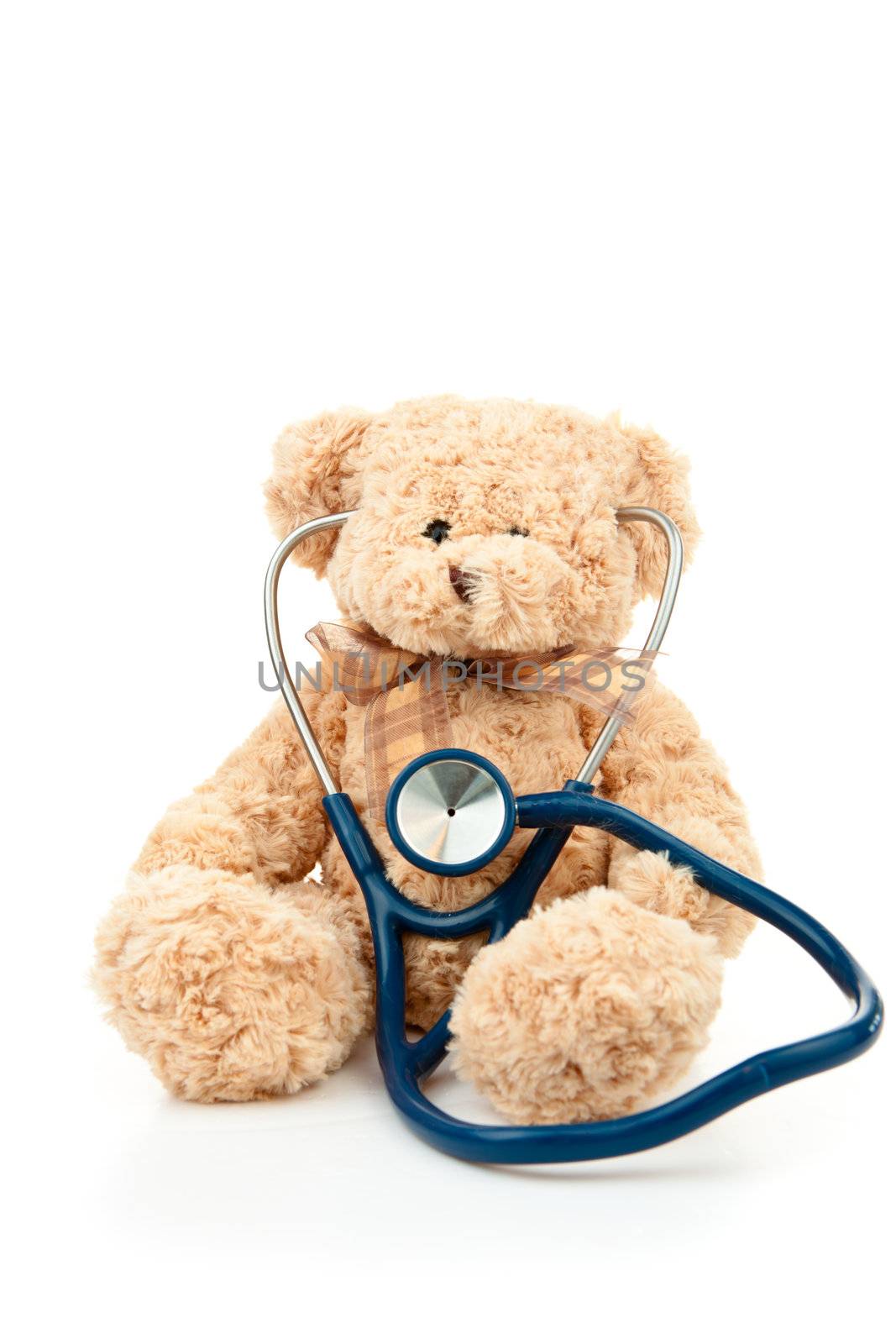 Teddy bear with a stethoscope against a white background