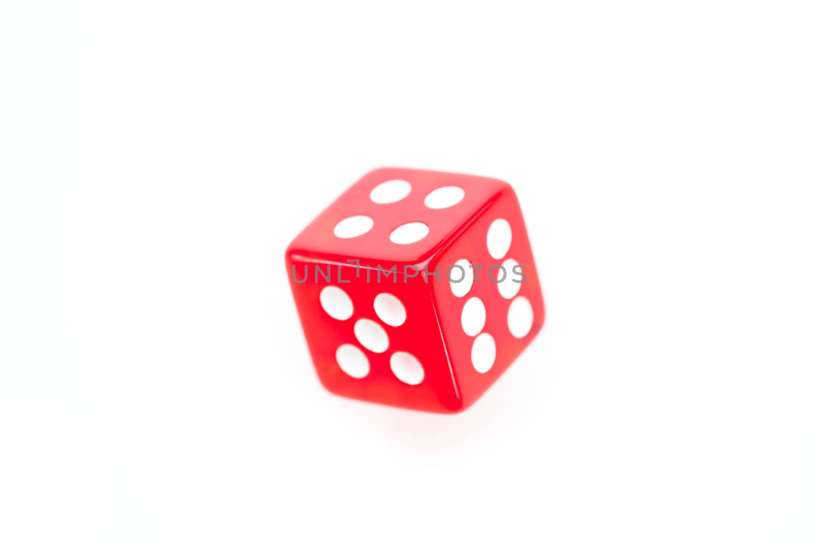 Red dice in motion against a white background