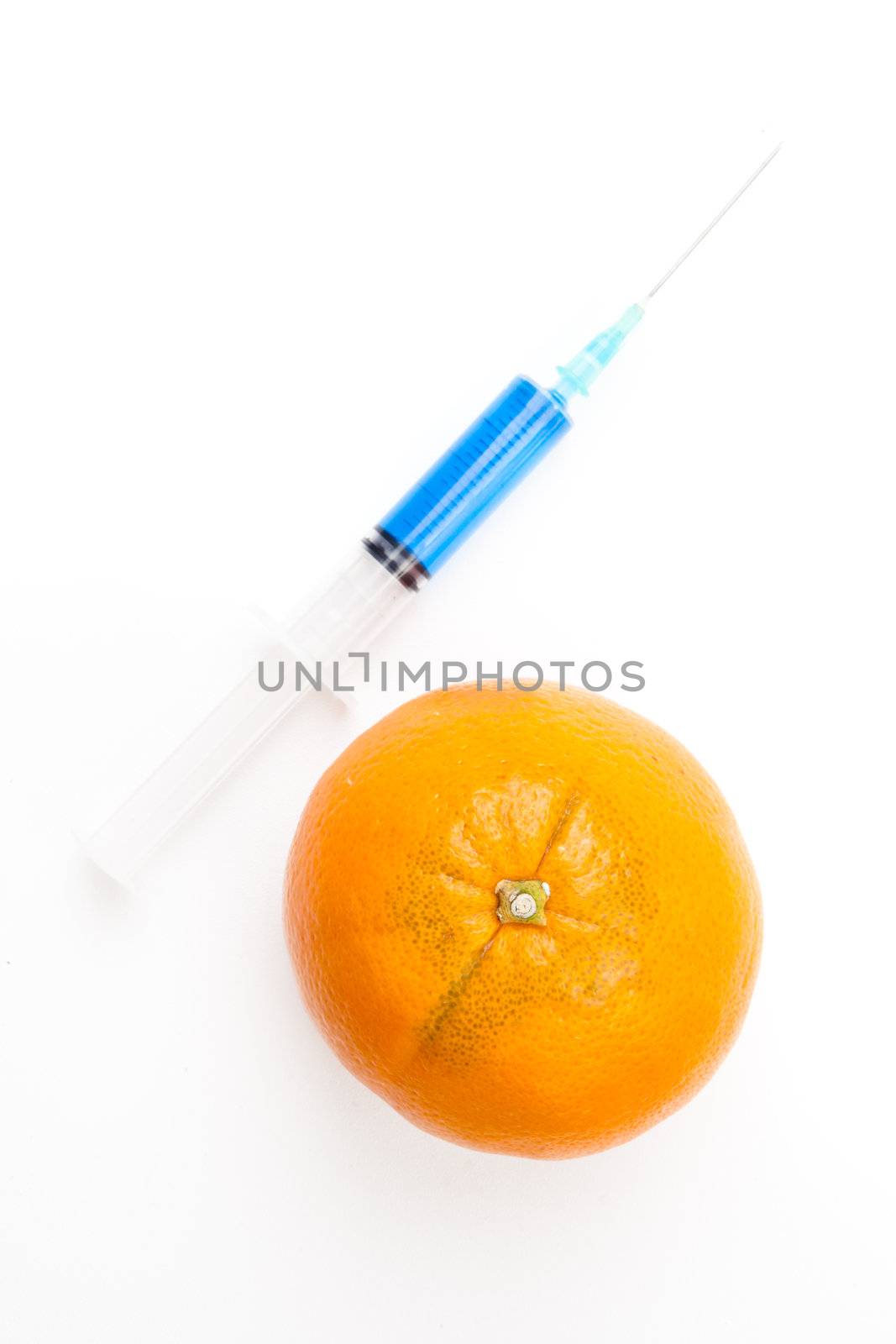 Orange next to a syringe against a white background