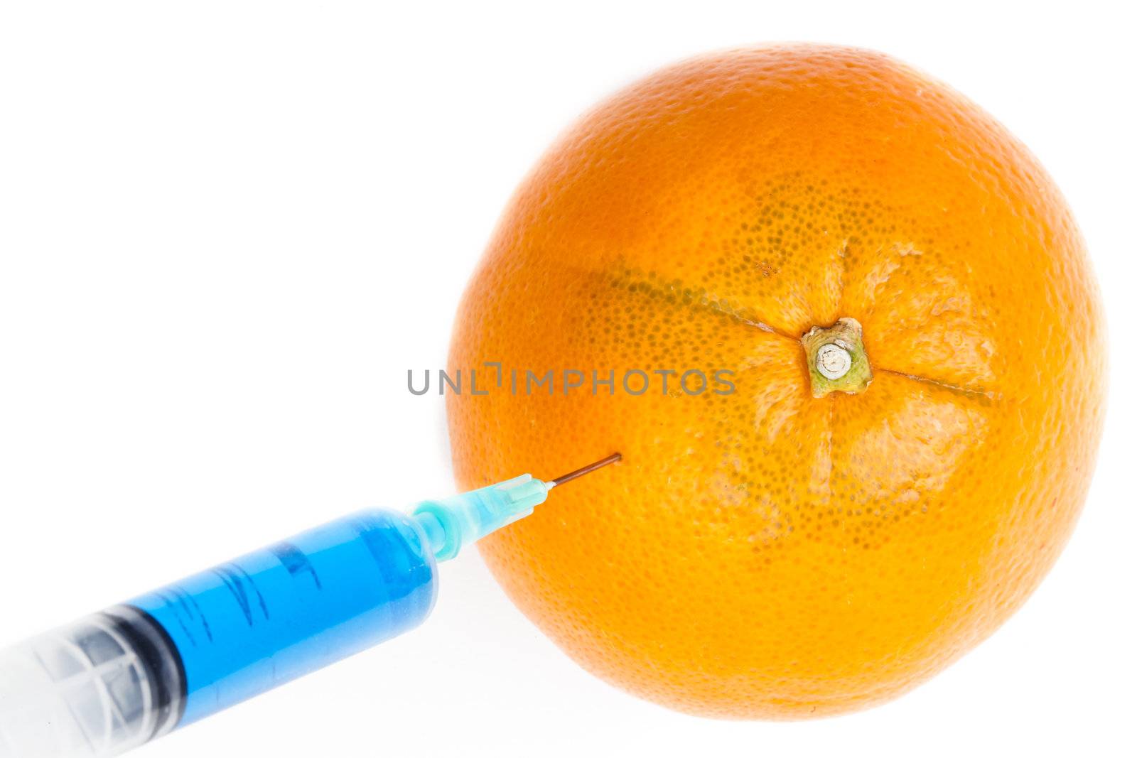 Syringe injecting in an orange against a white background