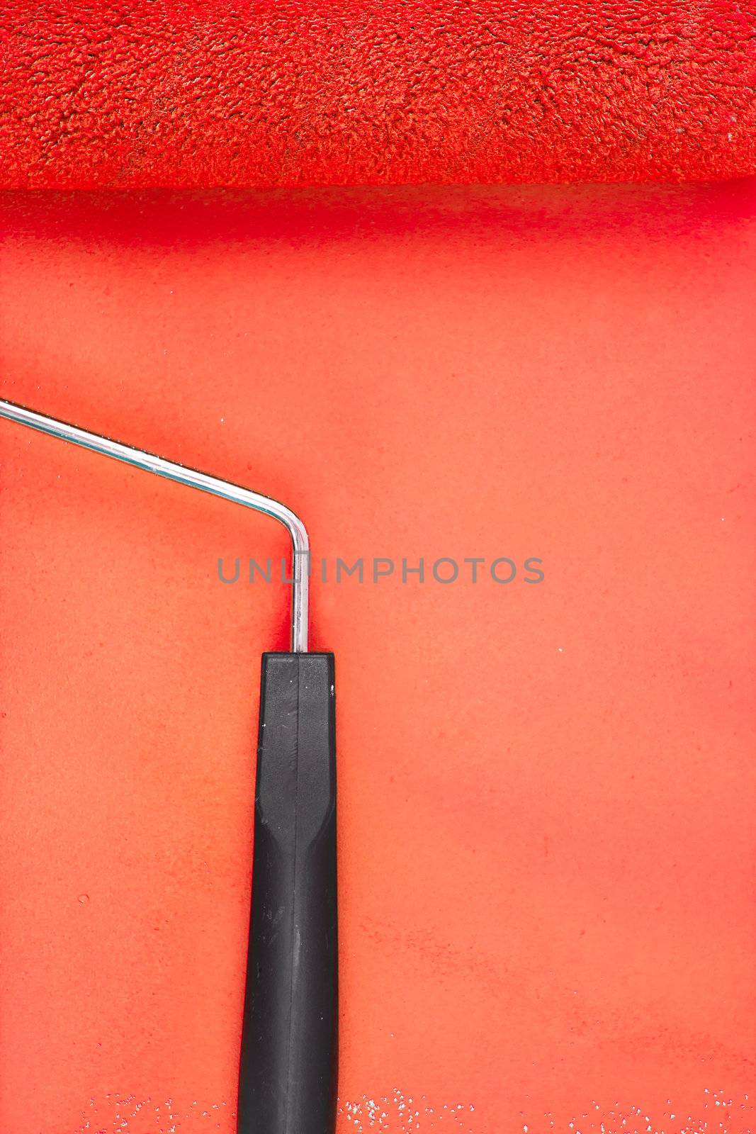 Red paint roller handle on a background by Wavebreakmedia