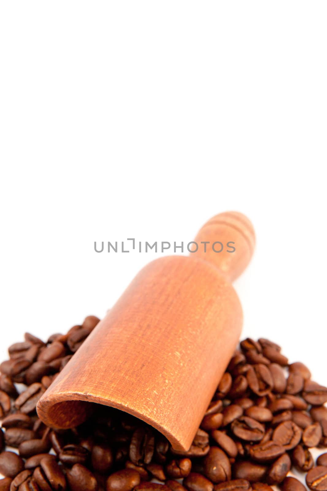 Wooden shovel put on beans coffee against a white background