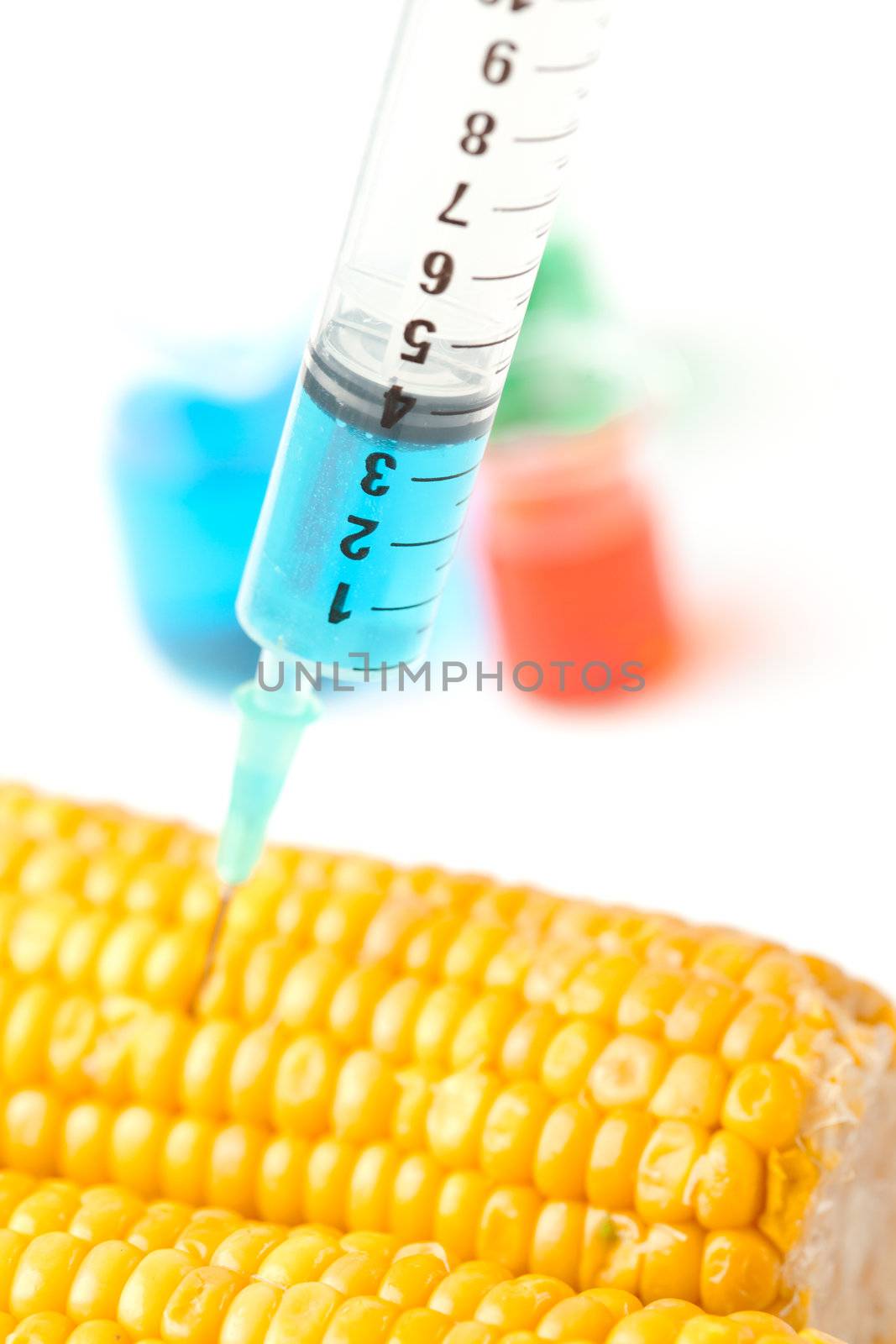 Syringe with corn against a white background