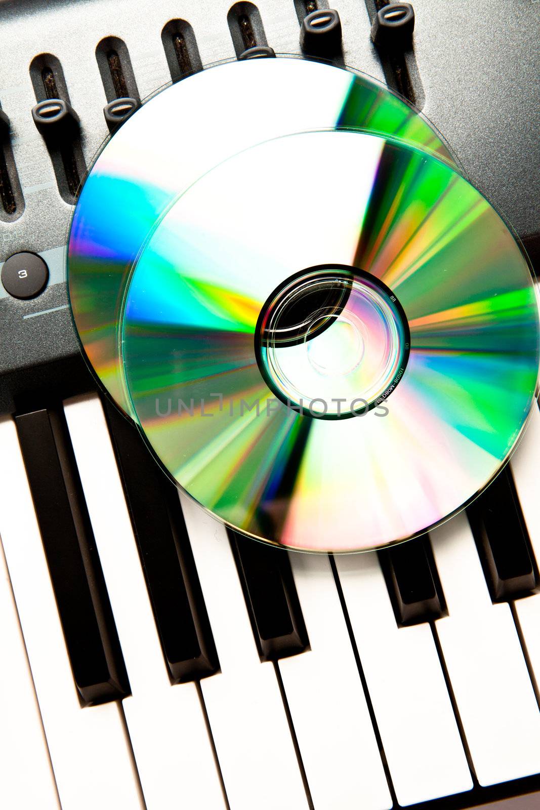 Close up of a compact disc on a synth by Wavebreakmedia