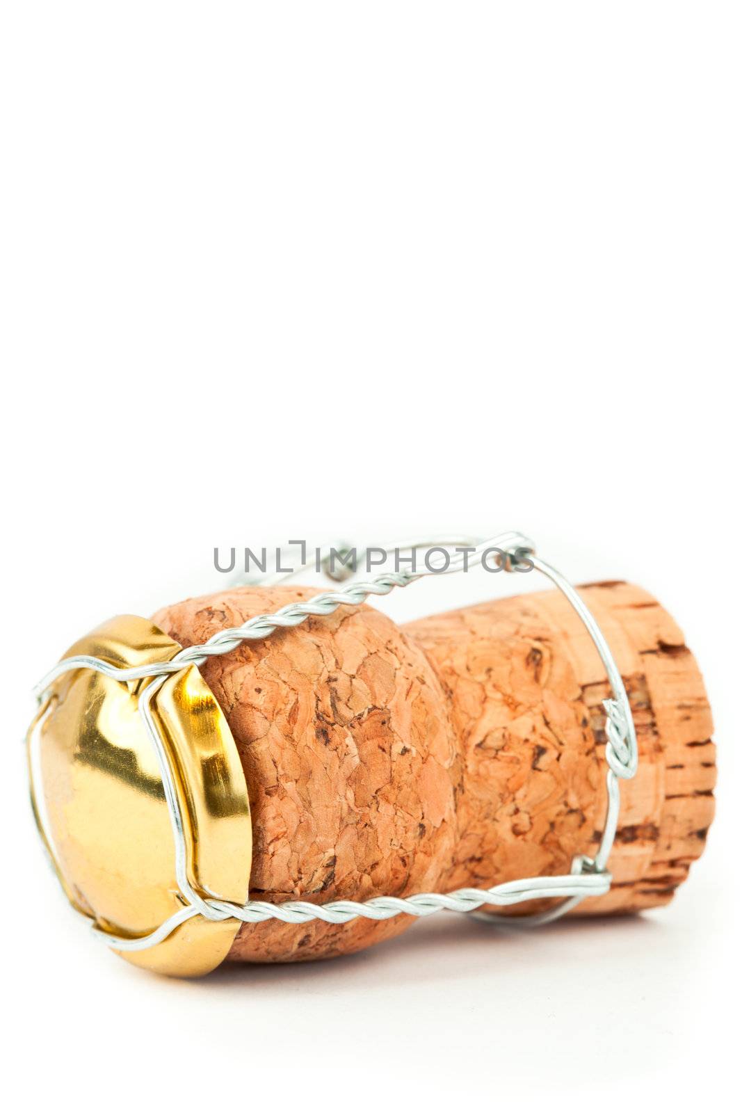 Close up of a cork with iron wire against a white background