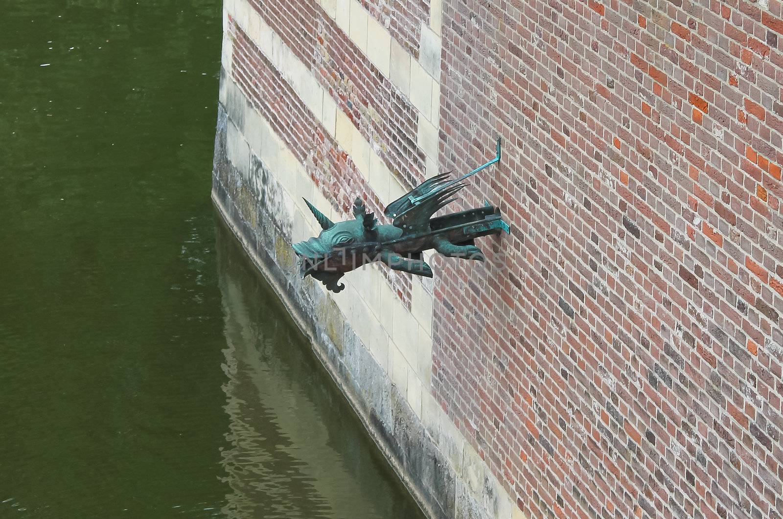 Gargoyle in the castle wall Heeswijk. Netherlands