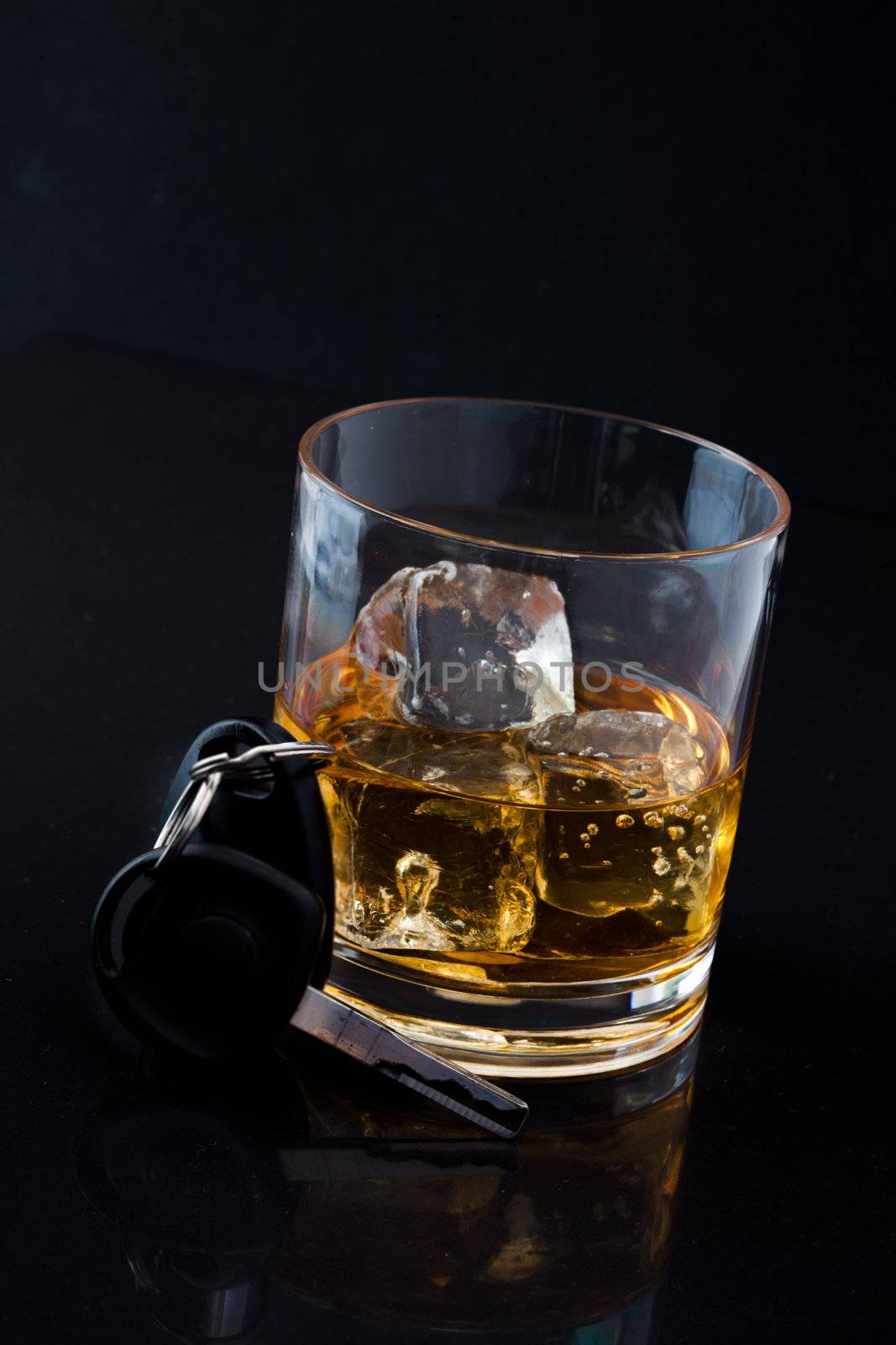 Whiskey on the rocks and car key by Wavebreakmedia