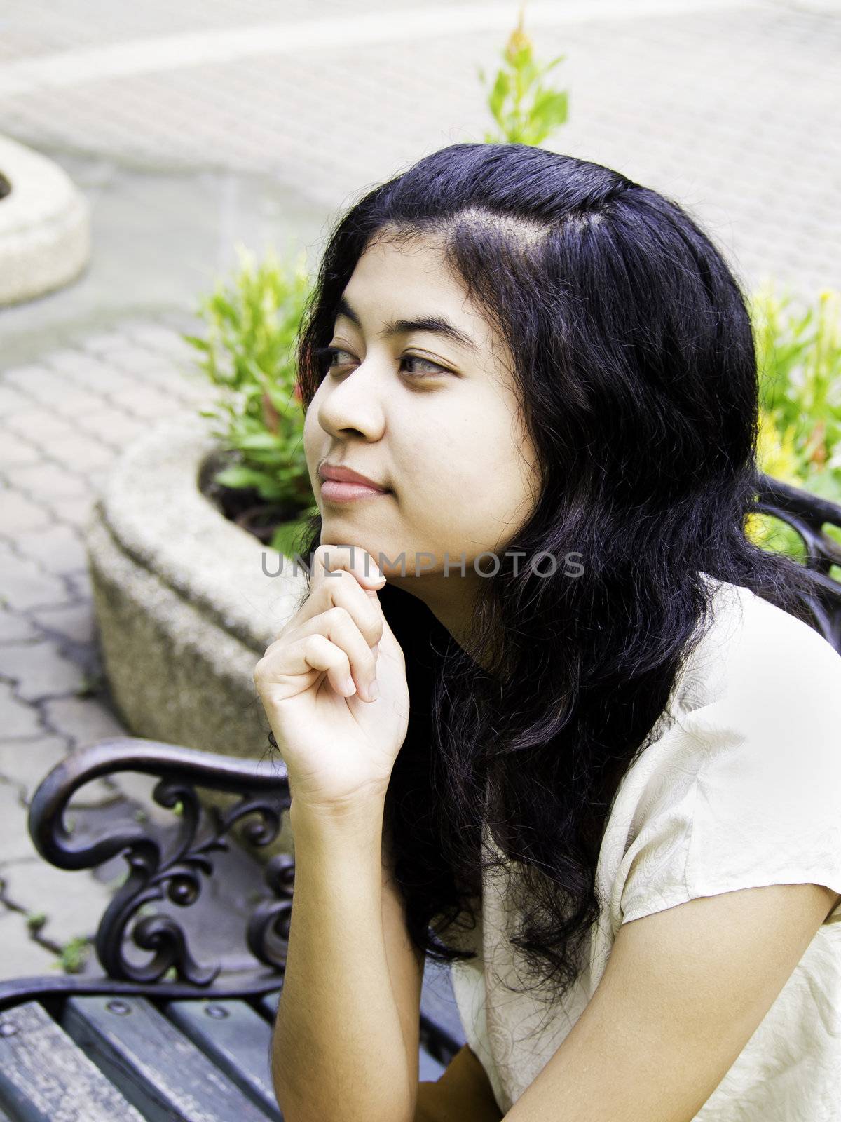 young girl thinking something at public park, outdoor