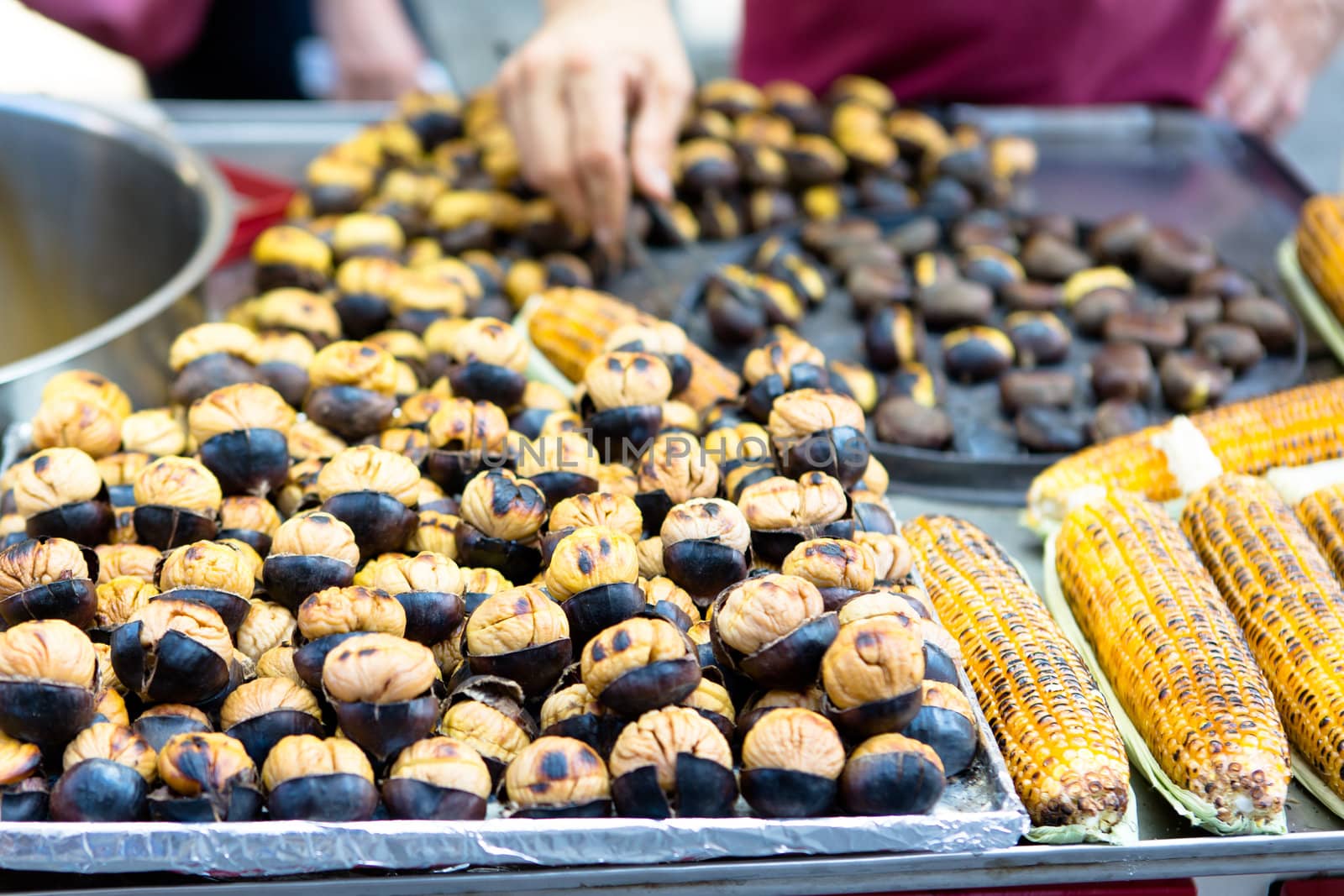 Roasted chestnuts and chorns are on sale, ready to eat.