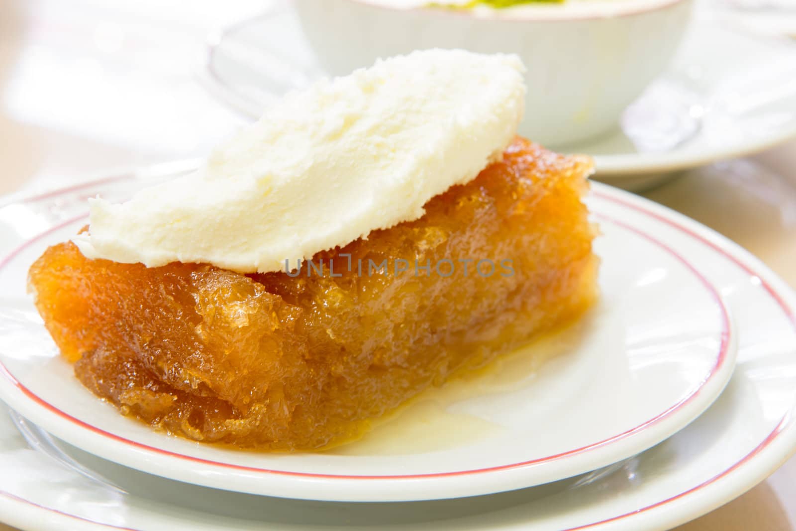 Traditional Turkish dessert Ekmek Tatlisi made with bread and sherbet, served with full milk fat.