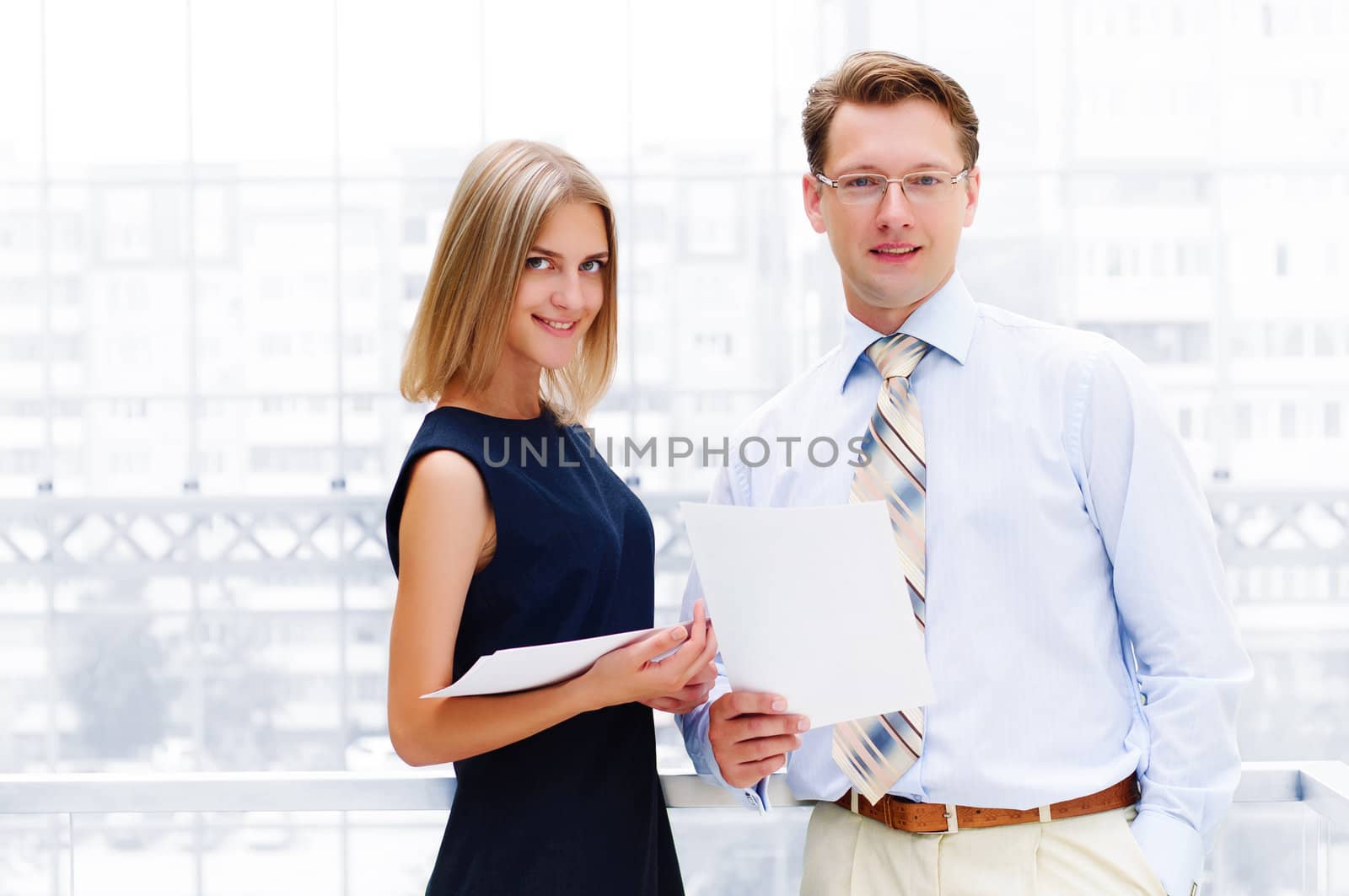 business man and business woman in the office to discuss reports by adam121