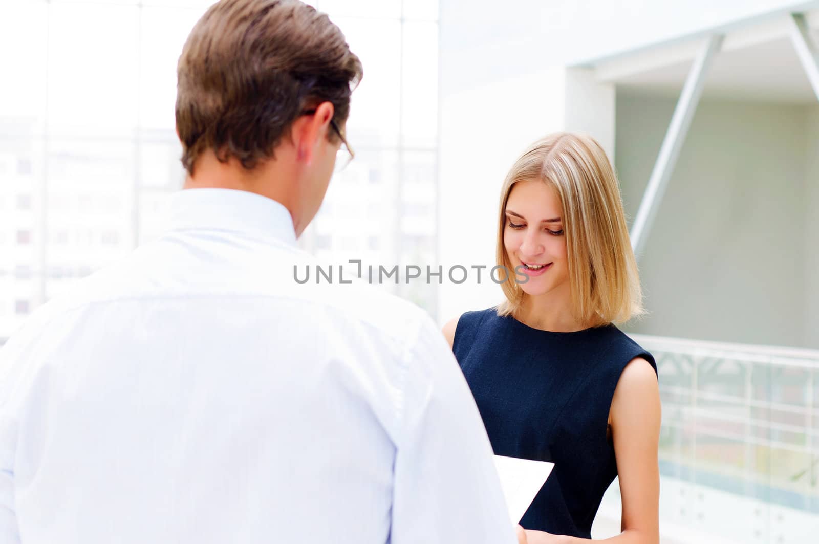 business man and business woman in the office to discuss reports by adam121