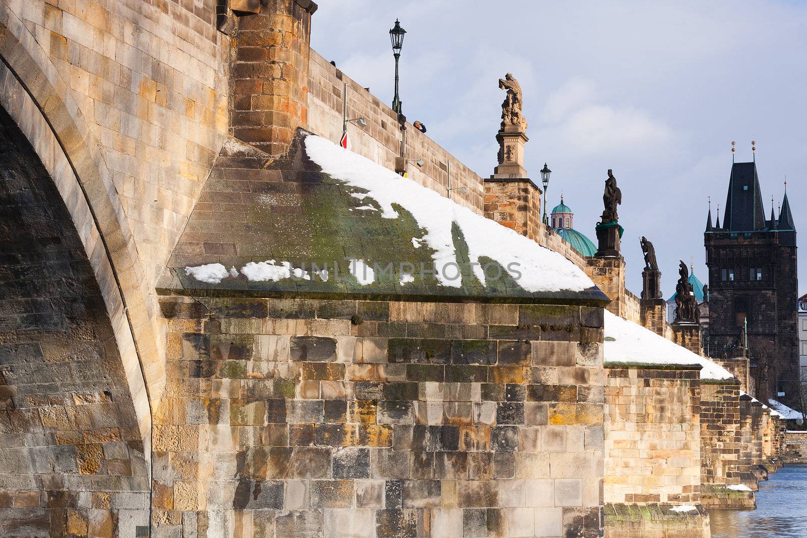 Famous Charles bridge on Vltava river in Prague in winter