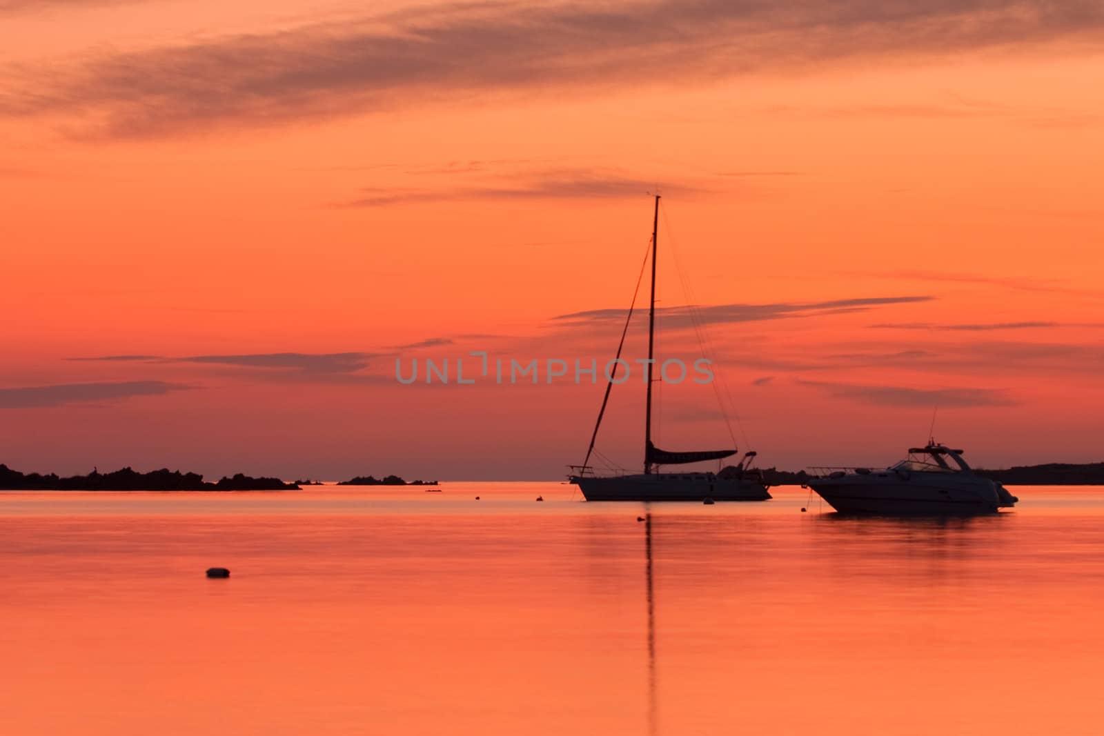 Yachts near the Tavolara island on the golden sunrise over the sea - Sardinia - Italy